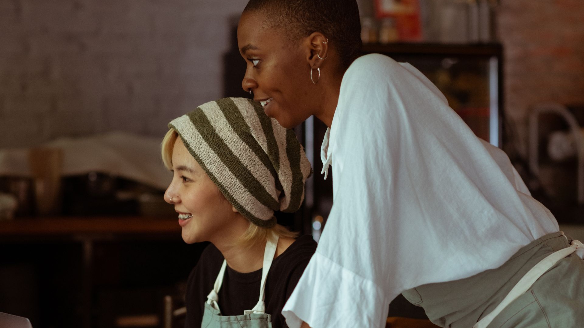 Small business owners reviewing their website together on a laptop
