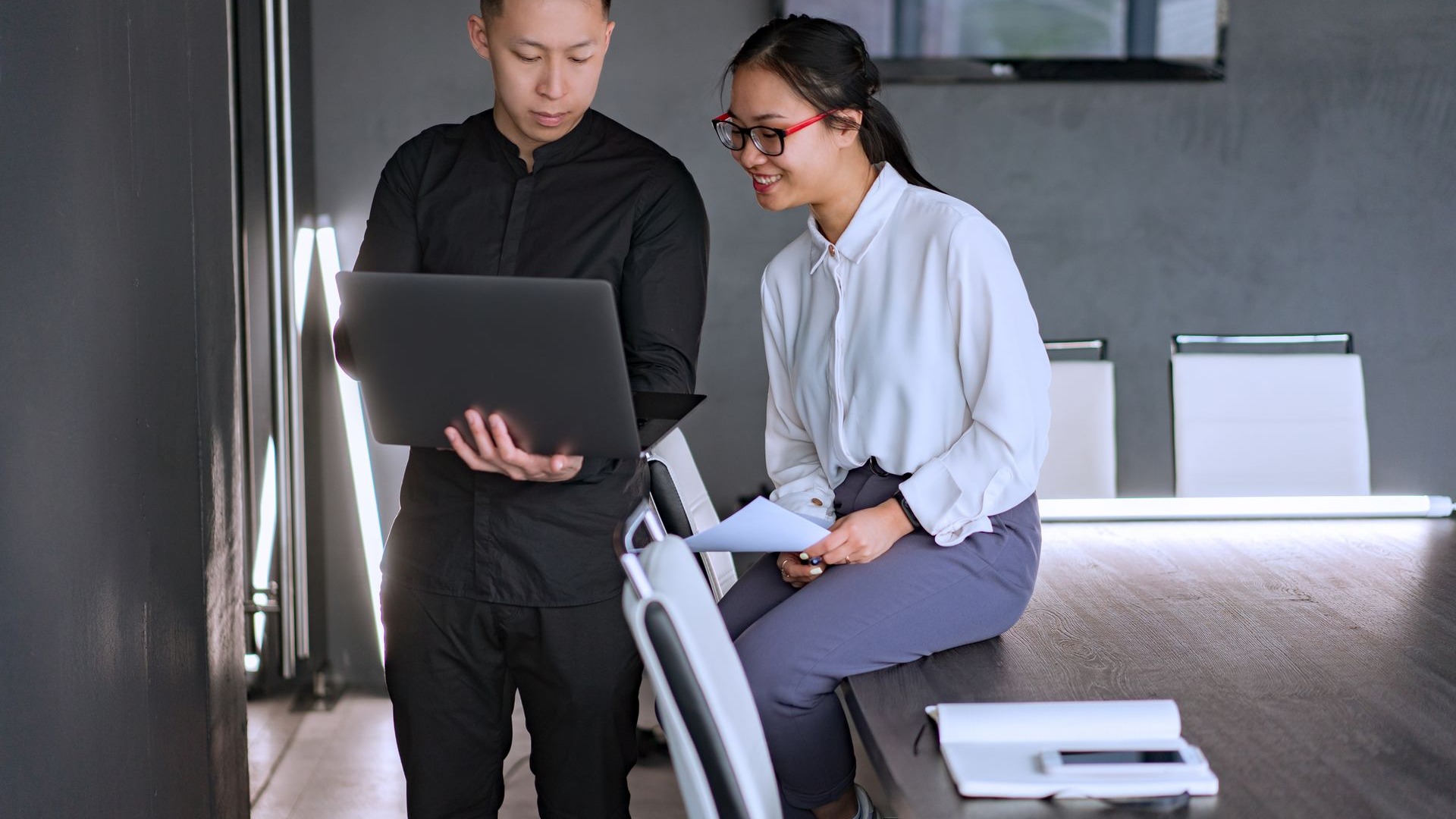 Two professionals reviewing an SEO strategy together on a laptop
